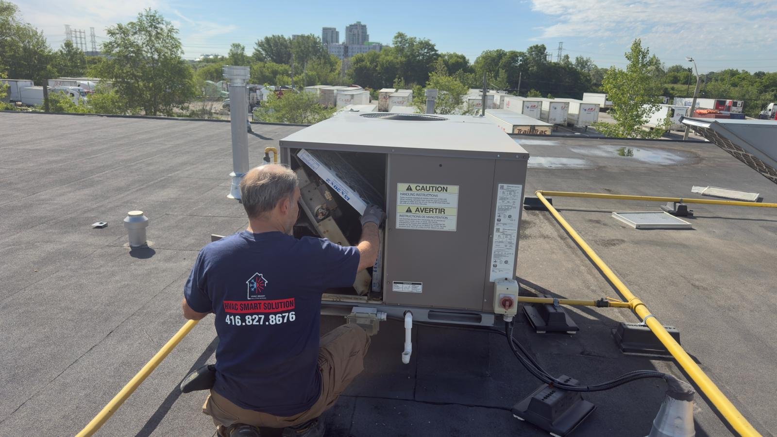 Technician servicing commercial rooftop HVAC unit Toronto